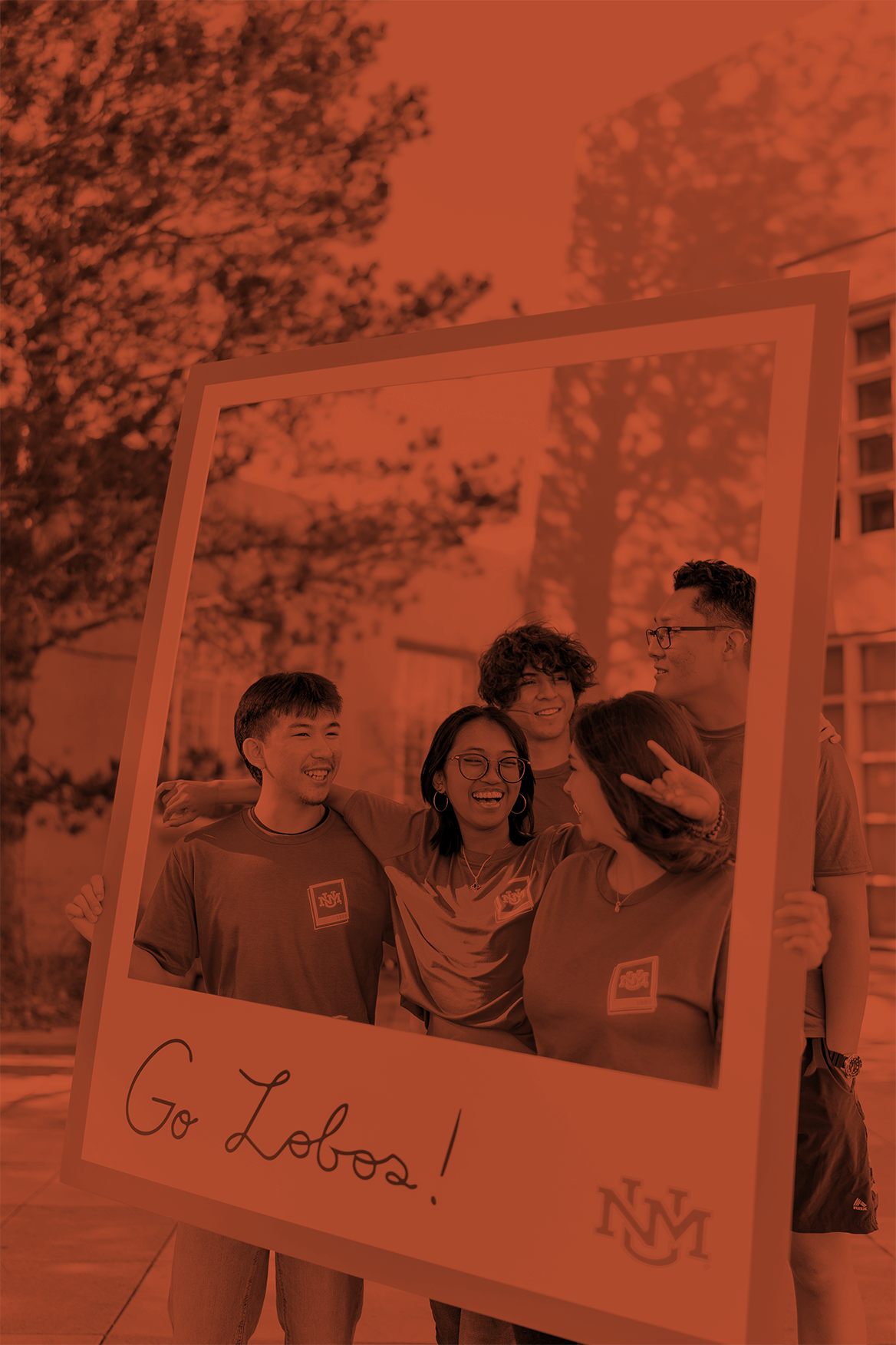 Students posing in large picture frame