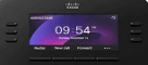 Close-up view of a Cisco desk phone screen displaying the time, date, and soft key options including Redial, New Call, and Forward.Close-up desk phone